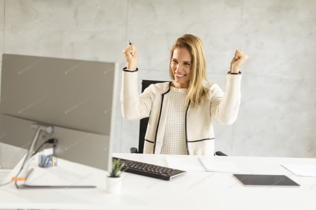 women cheering working on computer