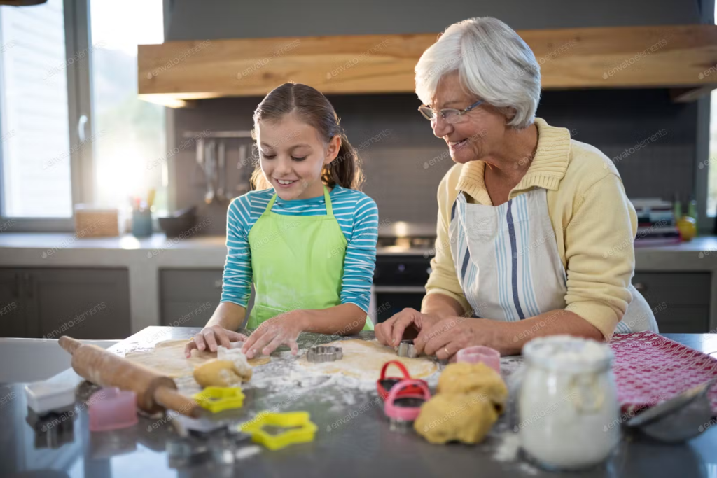 grandma and granddaughter cooking together cutting out cookies